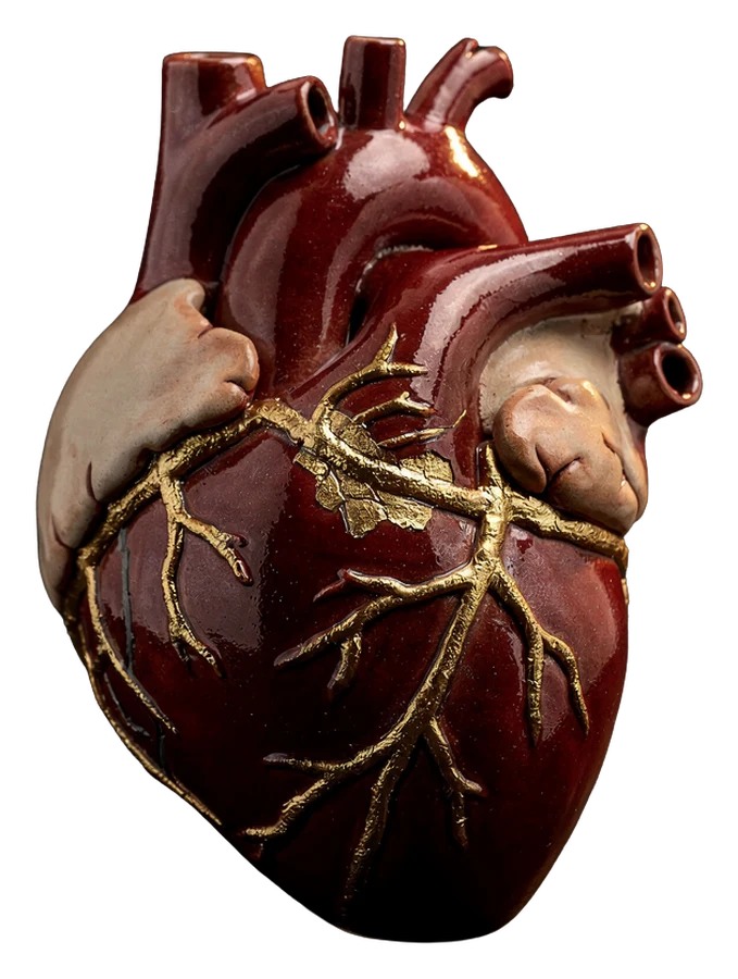 a deep-red ceramic heart repaired with kintsugi, gold veins glowing across its glaze